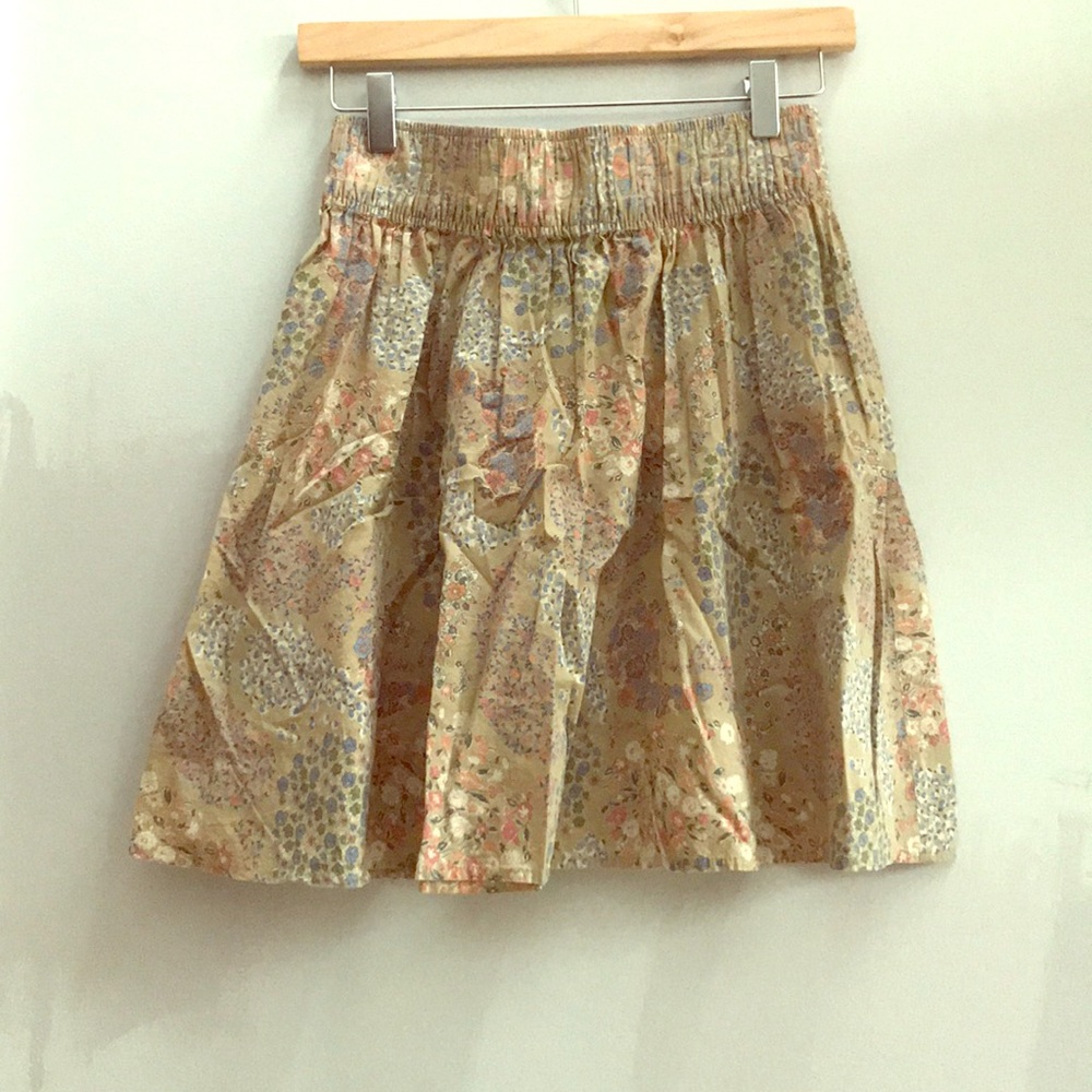 Short summer skirt. Tan with pastel colors.
